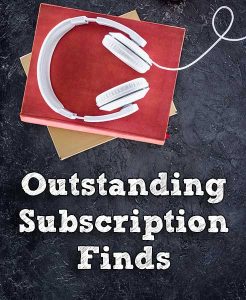A white pair of headphones on top of a stacked red and then brown book against a slate grey background with the words Outstanding Subscription Finds in white lettering below 