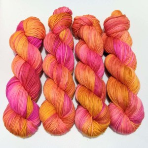 Skeins of bright pink and orange yarn.