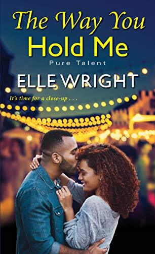 The Way You Hold Me by Elle Wright. A Black couple stands beneath a string of fairy lights. He is kissing her forehead and she has the sweetest smile on her face.