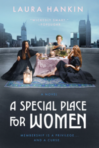 A special place for women paperback with a skyline of NYC with three women on a carpet wearing black gowns sitting around a pink tablecloth filled with candles and fruit and food it's very witchy vibes
