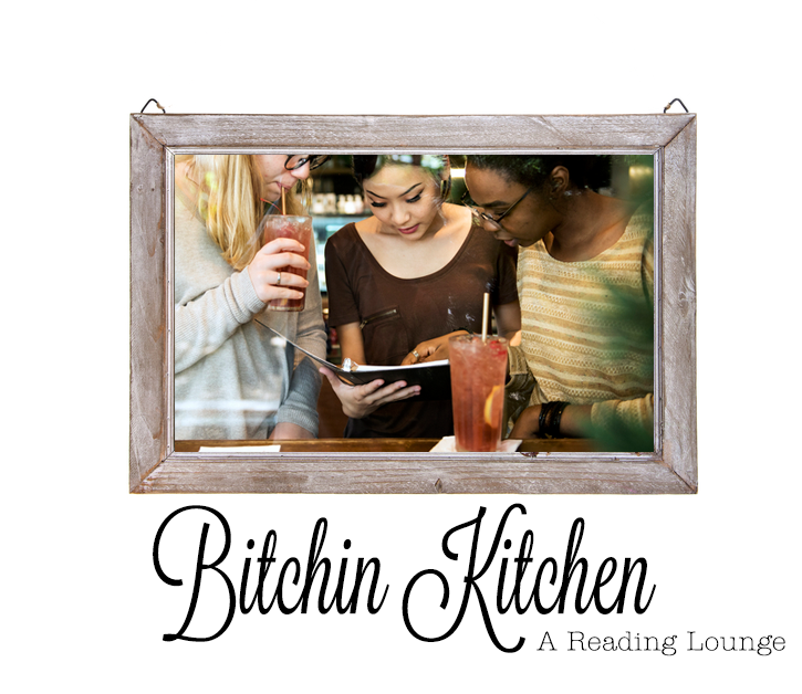 A wood frame picture of three women one white one asian and one black sipping mammoth cocktails and looking at a book together with the words Bitchin Kitchen Reading Lounge below them