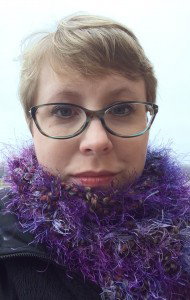 Close up of Elyse with a purple fluffy scarf