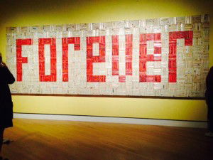 A long rectangle of white with FOREVER written in red - the text is made up of romance novel spines