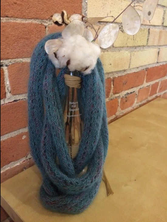 Scarf draped over a vase holding some cotton blossoms because why not?