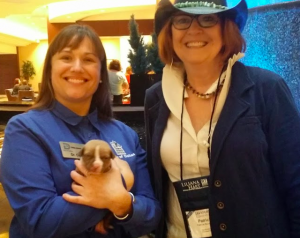 Dr. Mac from the Dallas Animal Shelter holding a three week old puppy