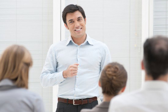 Smiling dude bro giving a speech with a high watt smile on his face.