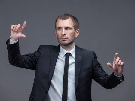 Portrait of business man pointing finger gestures, isolated on white on grey background. Concept of leadership and success