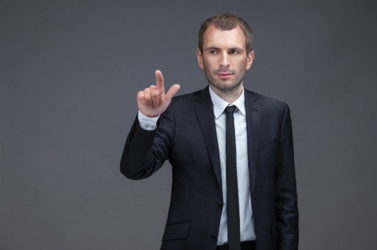 WHO MAKES UP THESE CAPTIONS JESUS STOCK PHOTO PEOPLE ARE WEIRD: Portrait of manager pointing finger gestures, isolated on grey background. Concept of leadership and success