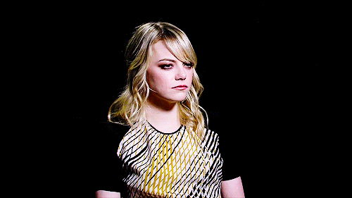 emma stone is very bored. so bored. She's pushing her lips out on a mild exhale.