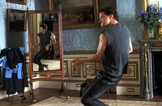 Colin Firth rocking out in front of an oval mirror wearing black leather pants 