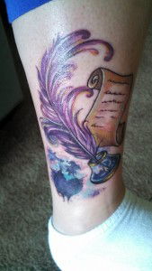 An ink well and scroll tattoo on a woman's ankle and calf