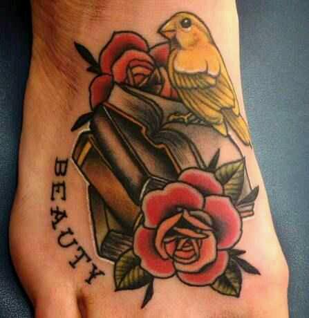 a yellow bird perched on a stack of books with roses and the word Beauty