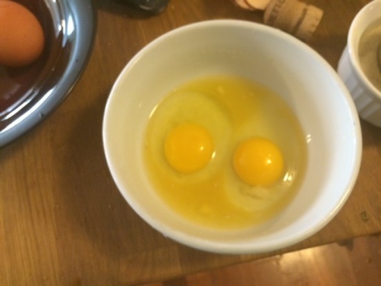 Eggs in a bowl with sugar and orange juice added