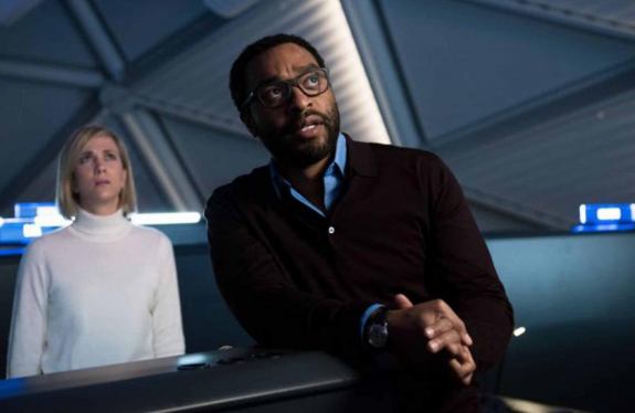 Chiwetel Ejiofor and Kristen Wiig in The Martian. Wiig is wearing a white turtleneck and Ejiofor has on a sweater, a blue collared shirt and glasses and there's a beard and you guys have no idea. RWOR.