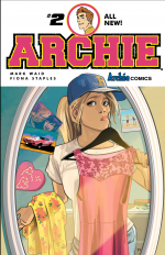 Betty in a ballcap holding up a dress in front of the mirror with another dress over her arm, her lips pursed to the side. Around the edge of the mirror are pictures and mementos of her relationship with archie