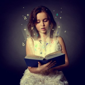 Young girl reading a sparkling Magic book