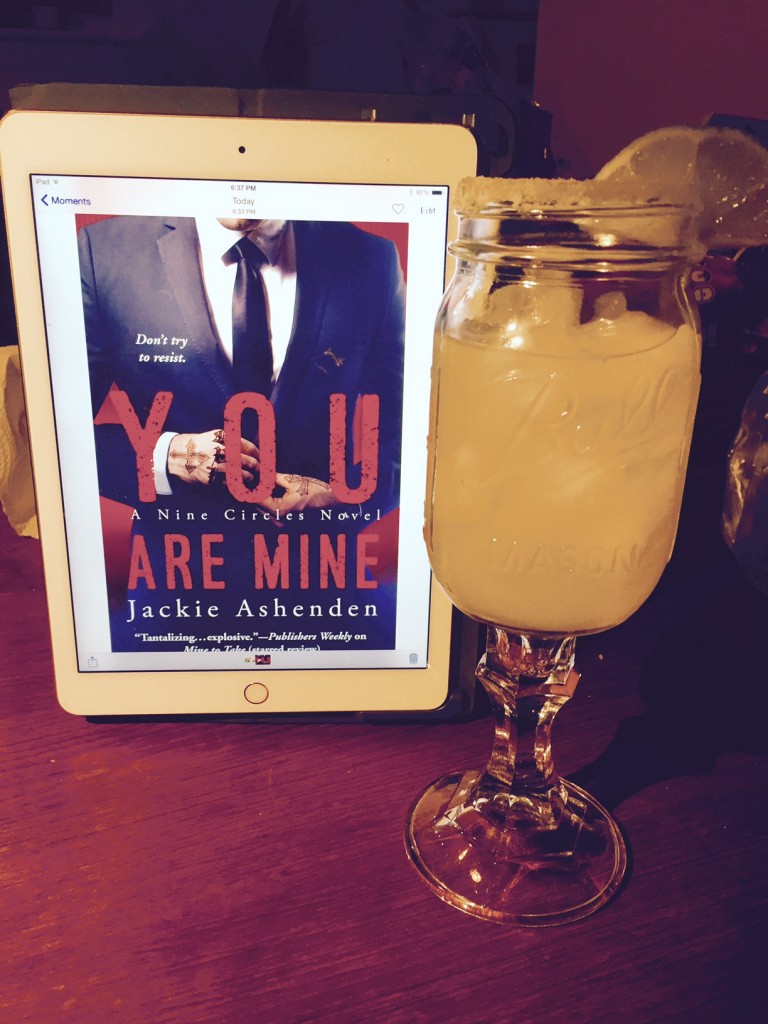 spicy lime margarita alongside an iPad with the cover for You Are Mine - a dude in a suit about to unbutton his jacket and his hands are covered with tats. Yowser. 