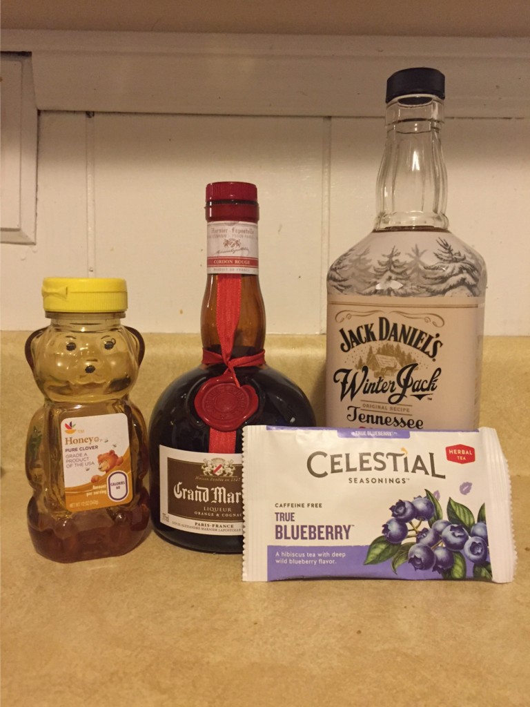 Ingredients for a blueberry hot toddy - blueberry tea, honey, grand marnier, and Jack Daniel's