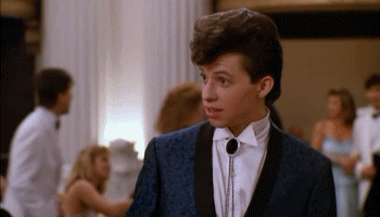 Ducky aka Jon Cryer looking at something offscreen, then looking straight into the camera with a Do You Believe This expression, then back offscreen