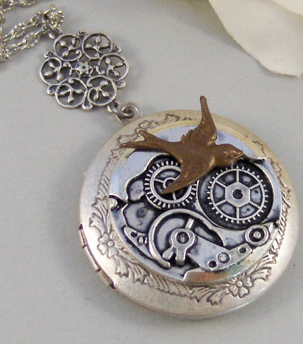 Steampunk locket with a round locket on a chain, with gears and a bird flying over it in brass and other metals