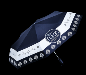A deep blue umbrella with art deco diamons around the brim that says Miss Phryne Fisher 