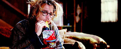 Johnny Depp, looking scruffy and morose wrapped in a blanket eating Doritos slowly