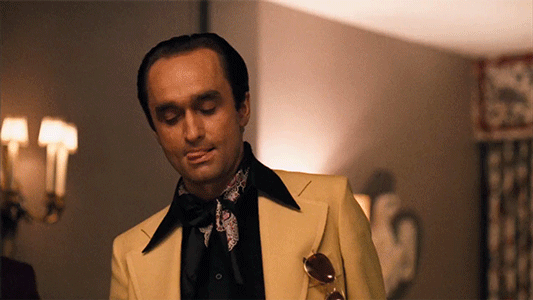 dude in a yellow suit from The Godfather sighing in annoyance and rolling his eyes