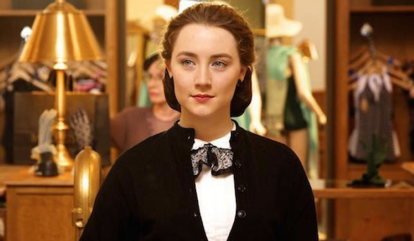 Saoirse Ronan in the department store, her hair in a cloche with a confident smile on her face