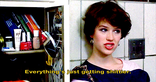 Molly Ringwald leaning on a locker saying Everything is just getting shittier
