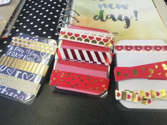 clear plastic cards with strips of very decorative tape in red gold and white wrapped around them - this is washi tape and its incredibly cute