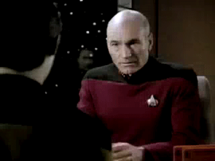 Picard dropping his face into both hands in disgust