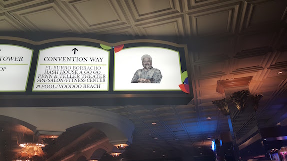 Little tiny cut out guy on a light up sign in the ceiling like bad photoshop hovering over us all 