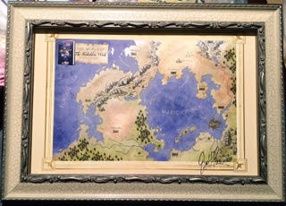 Lia's framed map of the world from The Forbidden Wish 