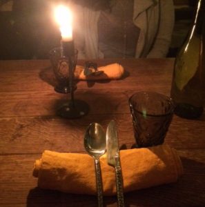 Table setting! Water glass, spoon, knife, on a napkin.