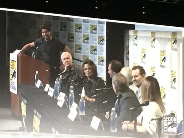 Hall H Aliens panel, 2016, with Cameron, Weaver, the other actors whose faces are not visible at a table in front of microphones