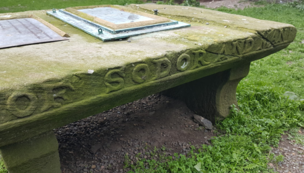 A mossy stone tablet inside the castle that reads SODOR AND PEEL - the diocese that includes the isle of man