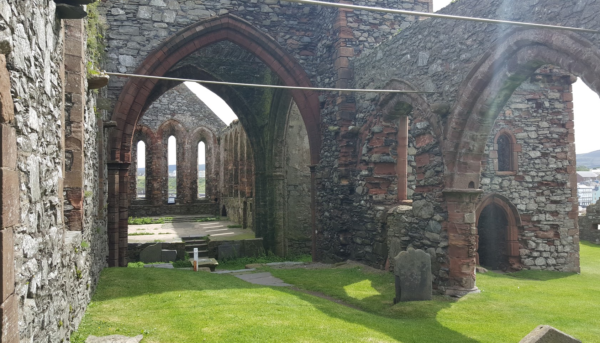 The inside of the main church. theres no ceiling and the ground is grass with graves everywhere