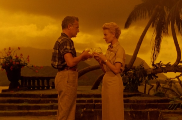 A man and woman toasting in front of a very concerning, yellow sky.