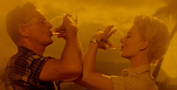 A man and woman drinking from glasses, but awkwardly pressing their elbows together. What is this.