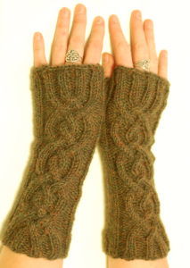 braided wrist warmers with thumb holes, with two long braids down the back of each wrist