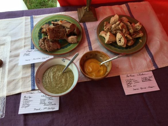 Mustard and green sauce plus beef and chicken each sauce and dish has a card in front listing ingredients 