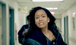 Two sisters running toward each other in a hallway breaking down and embracing