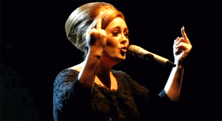 Adele flipping people off with both hands while singing in concert