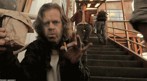 William H Macy flicking a cigarette at the camera with exactly zero fucks given
