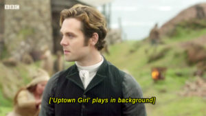 Enys, looking a bix godsmacked. The caption says ""Uptown Girl' plays in the back ground."