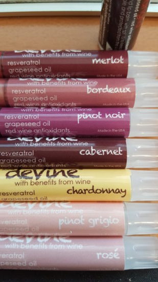 A close up of the lip shimmers in merlot, bordeaux, pinot noir, cabernet, chardonnay, pinot grigio, and rose the colors ranging from dark plum wine to very light pink 