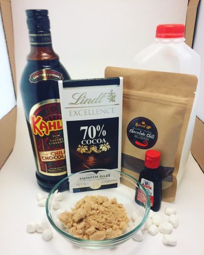 Ingredients for a spicy hot chocolate - kahlua, 70 percent dark chocolate, milk, chocolate chili sugar, vanilla and brown sugar