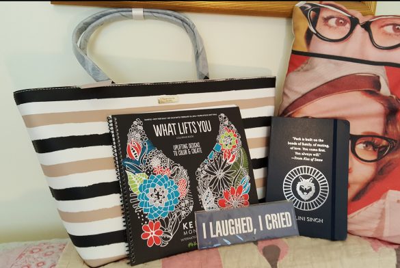Picture of bag with coloring book, bookmarks, and notebook