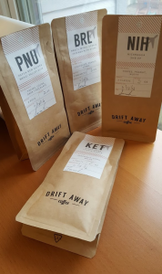 Photograph of the four 2 oz bags of coffee I was sent including some from Papua New Guinea, Kenya, and Brazil