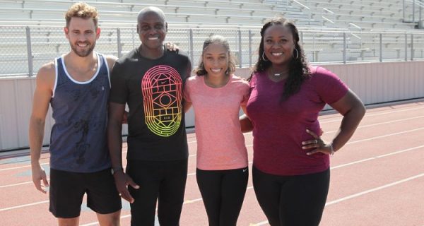 Nick poses for a picture with Michelle Carter, Carl Lewis and Allyson Felix.